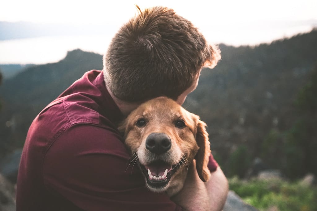 photo of man hugging tan dog Niagara County SPCA