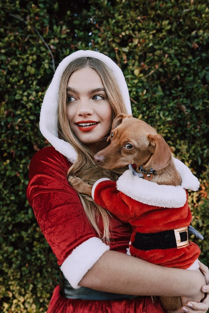 Matching Dog and Owner Shirts Woman In Santa Outfit Carrying Her Dog Wearing A Santa Costume
