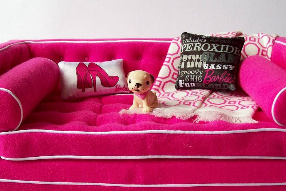 a pink colored dog sofa